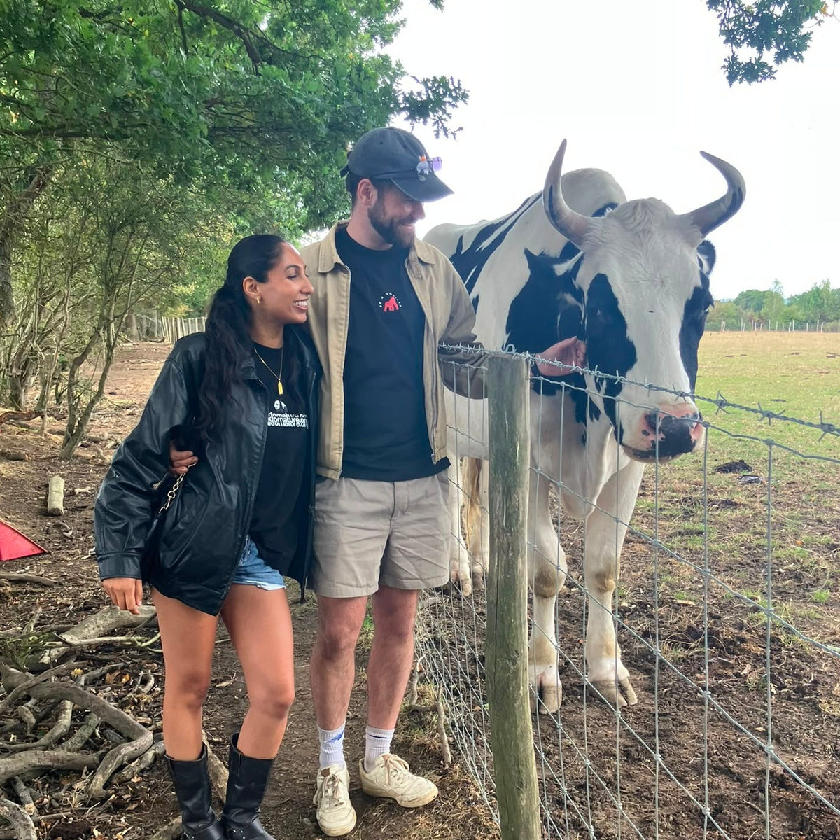 VedgeOut founder, Rory, connects with a beautiful black and white rescue cow at the Retreat Animal Rescue animal sanctuary.